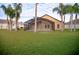 Large backyard with a screened patio and lush grass at 2612 Keswick Ct, Kissimmee, FL 34744