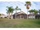 Backyard view showing a house with screened patio at 2612 Keswick Ct, Kissimmee, FL 34744