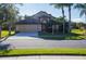 Tan one story house with a brown door and two car garage at 2612 Keswick Ct, Kissimmee, FL 34744