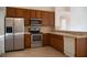 Kitchen with stainless steel appliances and wood cabinets at 2612 Keswick Ct, Kissimmee, FL 34744