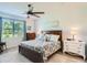 Comfortable bedroom featuring a ceiling fan, side tables and plenty of natural light at 2812 Ruby Rose Ln, St Cloud, FL 34771