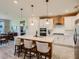 Bright and airy kitchen featuring a large center island with bar seating and pendant lighting at 2812 Ruby Rose Ln, St Cloud, FL 34771