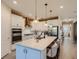 Stylish kitchen with white cabinetry, stainless steel appliances, and a spacious island with pendant lighting at 2812 Ruby Rose Ln, St Cloud, FL 34771