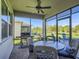 Screened patio with ceiling fan, dining table and chairs, and a view of the backyard at 2812 Ruby Rose Ln, St Cloud, FL 34771