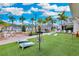 Recreation area with artificial turf, lawn games, benches, and palm trees at 2812 Ruby Rose Ln, St Cloud, FL 34771