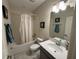 Clean bathroom with a shower/tub combo, gray vanity, and tiled floor at 2900 Title St, Kissimmee, FL 34746