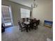 Bright dining room with table and chairs,tile floor, and access to backyard at 2900 Title St, Kissimmee, FL 34746