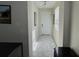 Bright entryway with tiled floor, white door, and mirrors at 2900 Title St, Kissimmee, FL 34746