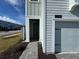 Front entrance of townhome with gray siding and a paved walkway at 2900 Title St, Kissimmee, FL 34746