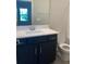 Modern bathroom with dark vanity and a toilet at 2916 Crest Wave Dr, Clermont, FL 34711