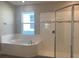 Relaxing bathroom with soaking tub and walk-in shower at 2916 Crest Wave Dr, Clermont, FL 34711