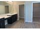 Elegant bathroom with double vanity, and access to a walk-in closet at 2916 Crest Wave Dr, Clermont, FL 34711