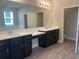 Elegant bathroom with double vanity and large mirror at 2916 Crest Wave Dr, Clermont, FL 34711