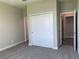 Bright bedroom with large closet and access to a hallway at 2916 Crest Wave Dr, Clermont, FL 34711