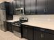 Modern kitchen with white quartz countertops and dark cabinetry at 2916 Crest Wave Dr, Clermont, FL 34711