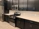 Modern kitchen with white quartz countertops and dark cabinetry at 2916 Crest Wave Dr, Clermont, FL 34711