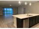 Modern kitchen with island, lake view, and stainless steel appliances at 2916 Crest Wave Dr, Clermont, FL 34711