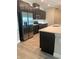 Modern kitchen with island, dark cabinetry, and stainless steel appliances at 2916 Crest Wave Dr, Clermont, FL 34711