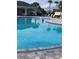 Community pool with lounge chairs and surrounding patio at 2916 Crest Wave Dr, Clermont, FL 34711