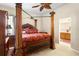 Bright bedroom featuring a wooden canopy bed and access to a bathroom at 2920 River Birch Dr, Kissimmee, FL 34741