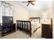 Serene bedroom with a dark wood bed frame and window at 2920 River Birch Dr, Kissimmee, FL 34741