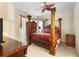 Spacious Primary bedroom with a large, ornate four-poster bed at 2920 River Birch Dr, Kissimmee, FL 34741