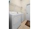 Bright laundry room, washer, dryer, and shelving at 2920 River Birch Dr, Kissimmee, FL 34741