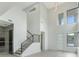 Two-story entryway with modern staircase and high ceilings at 3015 Kensington Ave, Davenport, FL 33837