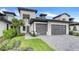 Modern two-car garage with grey stone and sleek design at 3015 Kensington Ave, Davenport, FL 33837