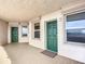 Building hallway with tiled floors and green doors at 3311 S Atlantic Ave # 1402, Daytona Beach, FL 32118