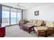 Bright living room featuring wicker furniture and ocean view at 3311 S Atlantic Ave # 1402, Daytona Beach, FL 32118