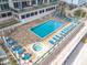 Elevated pool and sundeck with numerous lounge chairs and hot tub at 3311 S Atlantic Ave # 1402, Daytona Beach, FL 32118