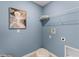 Laundry room with shelving, dog portrait, and fluffy pet bed at 3570 Fort Mellon Ln, Sanford, FL 32773