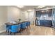 Modern dining room with blue chairs and a wood table, adjacent to kitchen at 4012 Breakview Dr # 405, Orlando, FL 32819