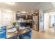 Modern dining room with blue chairs and a wood table, adjacent to kitchen at 4012 Breakview Dr # 405, Orlando, FL 32819