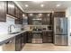 Modern kitchen with stainless steel appliances and dark wood cabinets at 4012 Breakview Dr # 405, Orlando, FL 32819