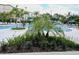 Community pool with lounge chairs and umbrellas, surrounded by tropical plants at 4012 Breakview Dr # 405, Orlando, FL 32819