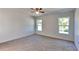 Bright bedroom with carpet flooring and two windows at 4601 Glencrest Loop, Saint Cloud, FL 34772