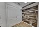 Laundry room with wood-look wall and shelving at 4601 Glencrest Loop, Saint Cloud, FL 34772