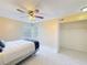 Bedroom with full-size bed, ceiling fan and large window at 4818 Marks Ter # 385 B2, Orlando, FL 32811