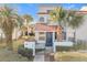 Two-story townhome with a tiled roof, gated entry, and landscaping at 4818 Marks Ter # 385 B2, Orlando, FL 32811