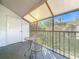 Relaxing screened balcony with table and chairs, and lush green view at 4818 Marks Ter # 385 B2, Orlando, FL 32811