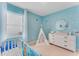 Bedroom with ocean-themed decor and crib at 5087 Tana Ter, Saint Cloud, FL 34772