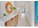 Bright and airy entryway with decorative mirror and console table at 5087 Tana Ter, Saint Cloud, FL 34772