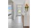 Light-filled entryway with white console table and mirror at 5087 Tana Ter, Saint Cloud, FL 34772