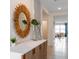 Bright and airy entryway with decorative mirror and console table at 5087 Tana Ter, Saint Cloud, FL 34772