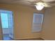 Spacious bedroom with French doors and ceiling fan at 5112 Conroy Rd # 13, Orlando, FL 32811