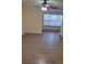 Bright living room features wood-look tile floors at 5112 Conroy Rd # 13, Orlando, FL 32811