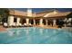 Resort-style pool with lounge chairs and adjacent building at 5112 Conroy Rd # 13, Orlando, FL 32811