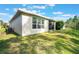 House exterior showcasing a screened patio and lawn at 560 Presido Park Pl, Kissimmee, FL 34759